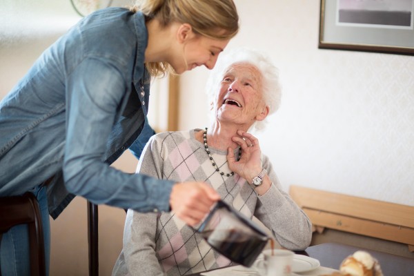 A carer helping an elderly person